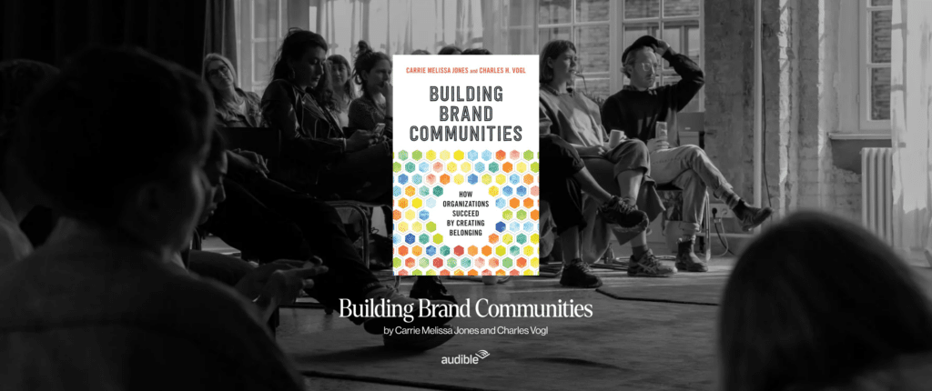 Book cover of “Building Brand Communities” by Carrie Melissa Jones and Charles Vogl, shown in a community gathering setting.