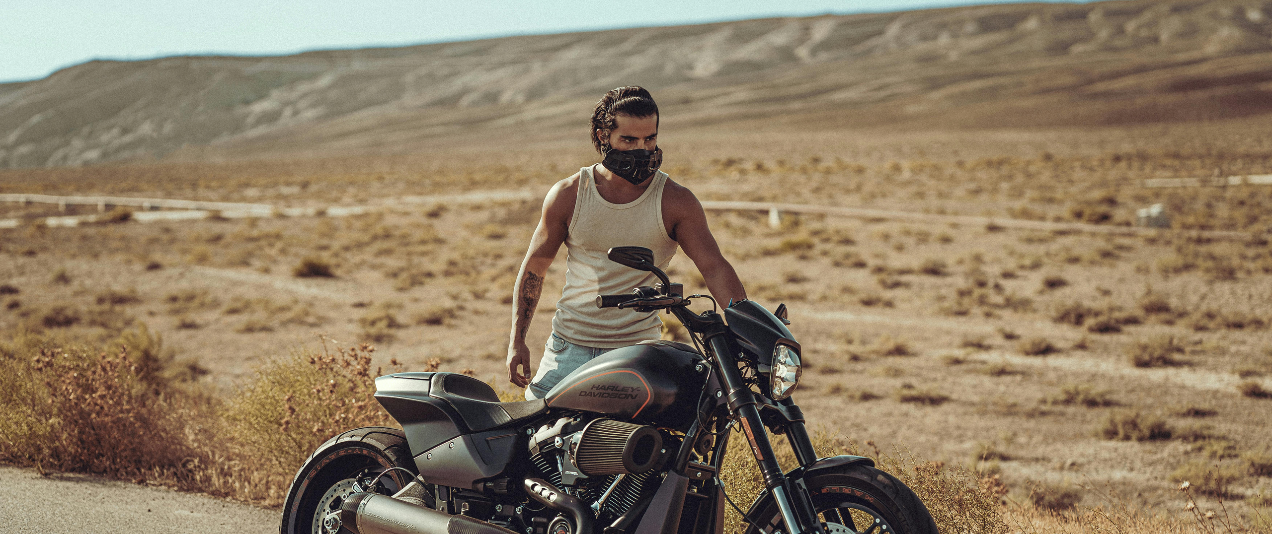 A man riding a motorcycle in the desert, symbolizing freedom, adventure, and the Harley-Davidson lifestyle.