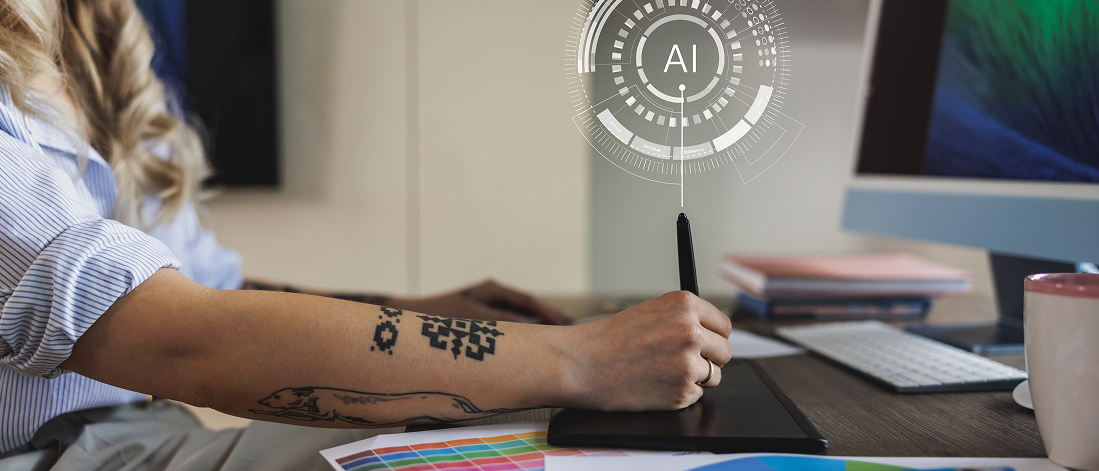 A person working at a desk with a drawing pen labeled "AI," representing the intersection of AI and design.