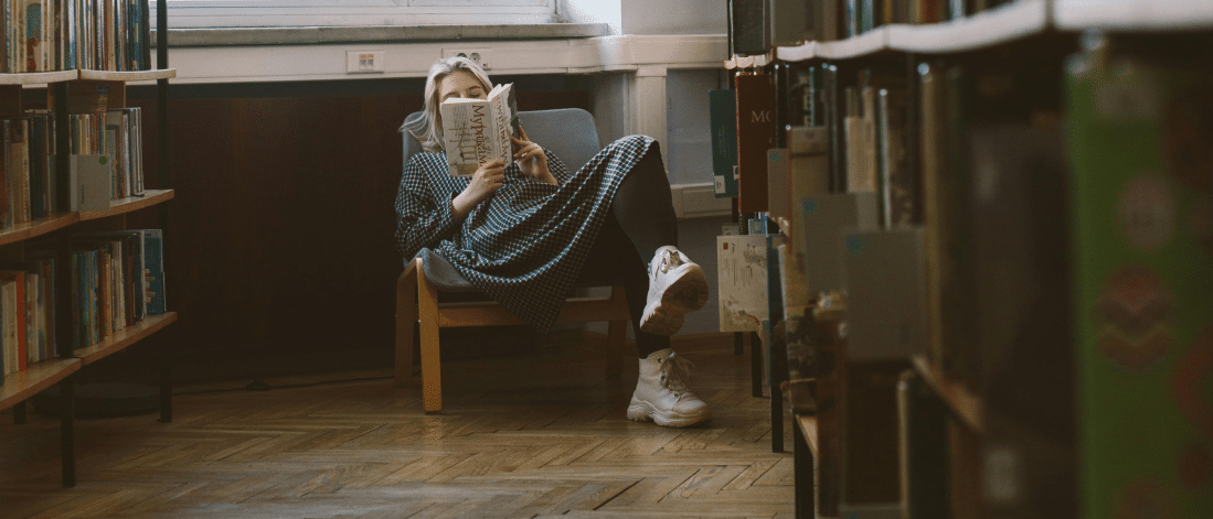 A peaceful scene of a woman in a seaside café, symbolizing the quiet moments that spark resilience and a growth mindset. These pauses allow space to process failure, gain clarity, and prepare for the next creative pivot in life.